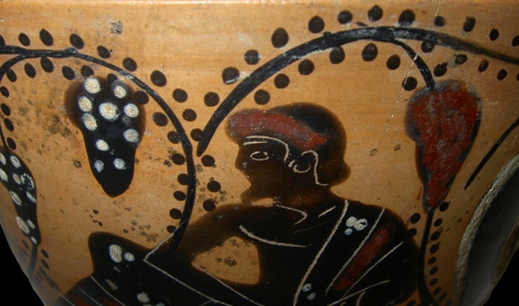 Man and vines on a black figure ware vessel