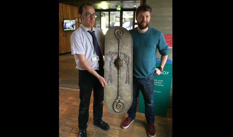 Tom Hughes presenting the shield to The Collection's Dr Erik Grigg